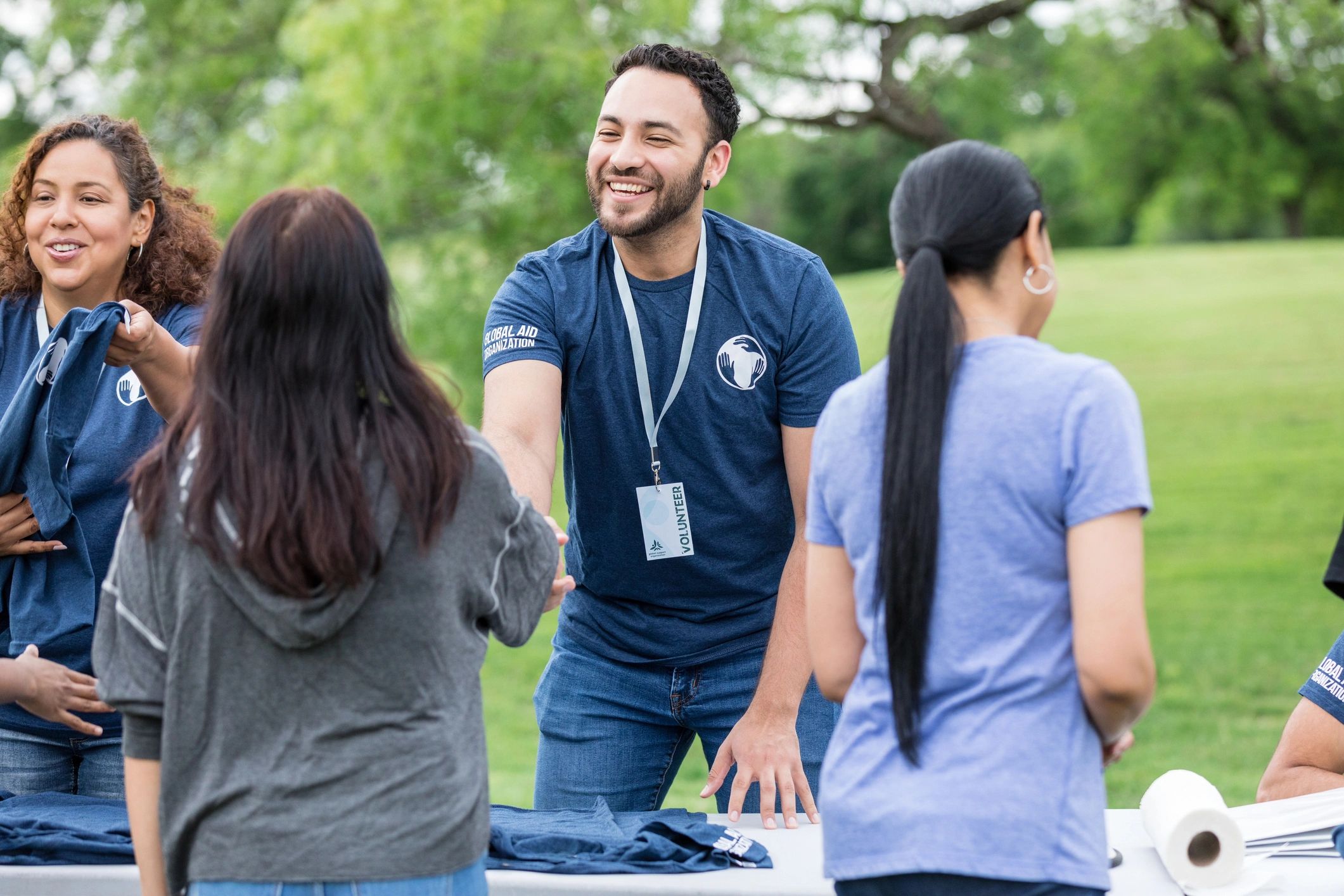 Volunteer greeting another helper during a community service project